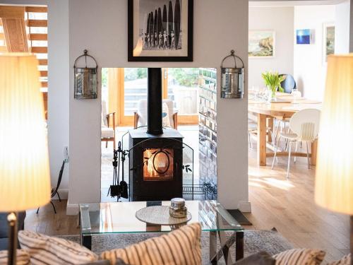 a living room with a wood stove in the middle at Peakaboo in Sidmouth