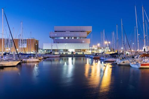 a marina with boats in the water at night at M.A.H 2 Le calme en hyper centre magnifique in Le Havre