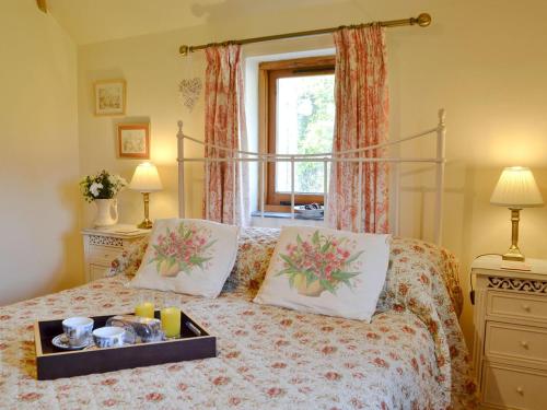 a bedroom with a bed with a tray on it at The Cart Lodge in Hooe