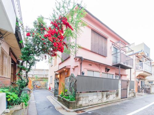 a pink building with flowers hanging off the side of it at 5min walk to Tokyo Skytree Sta -HANA ASAKUSA- in Tokyo