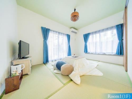 a living room with a bed and a tv at 5min walk to Tokyo Skytree Sta -HANA ASAKUSA- in Tokyo