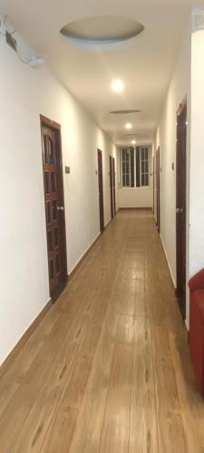 pusty korytarz z drewnianą podłogą i sufitem w obiekcie Le Grace Bye Pass w mieście Maduraj