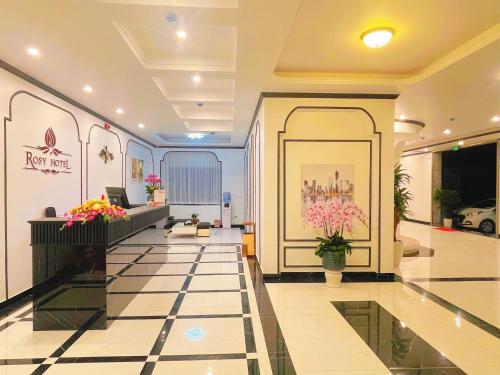 a lobby of a building with flowers on the wall at Rosy Hotel in Hanoi