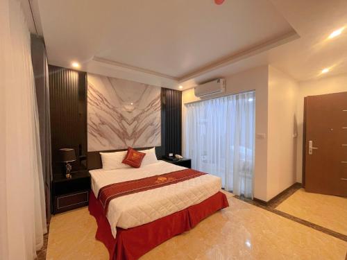 a hotel room with a bed and a large window at Rosy Hotel in Hanoi