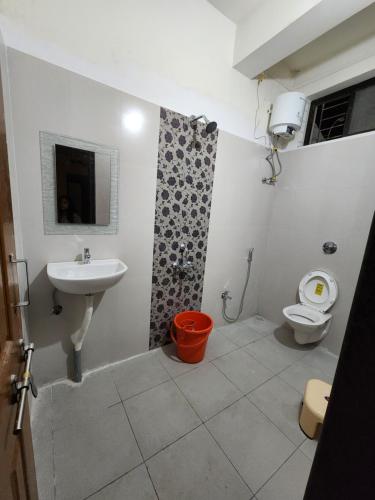 a bathroom with a sink and a toilet at VedGanga Plus Villa - Homestay in Kolhapur