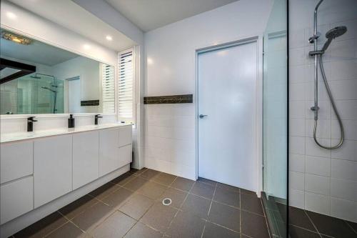 a bathroom with a shower and a glass door at Coastline: Alpine Villa in Mount Tamborine