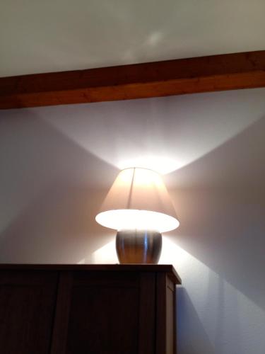 a lamp on top of a table in a room at Haus Ferdinand in Fernitz
