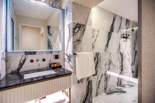a bathroom with a sink and a mirror at CC Palace Hotel in Rome
