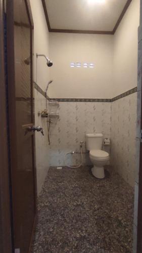 a bathroom with a toilet and a shower at Kristal Garden in Sekotong