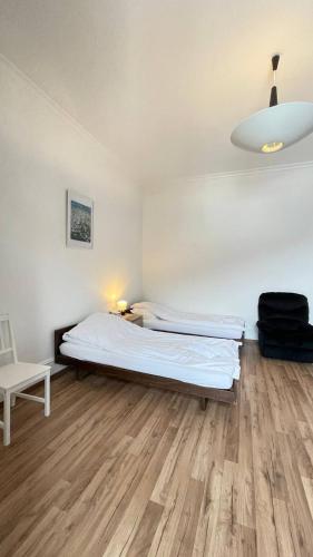 a bedroom with a bed and a wooden floor at Villa Zentrum Haus Davos in Davos