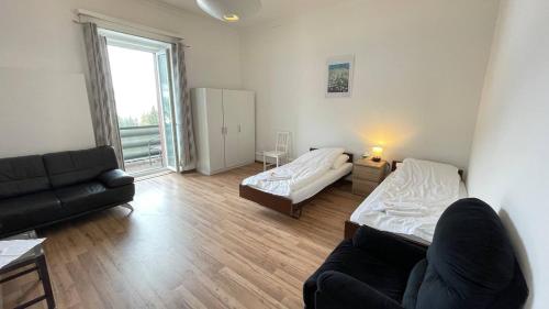 a living room with a bed and a couch at Villa Zentrum Haus Davos in Davos