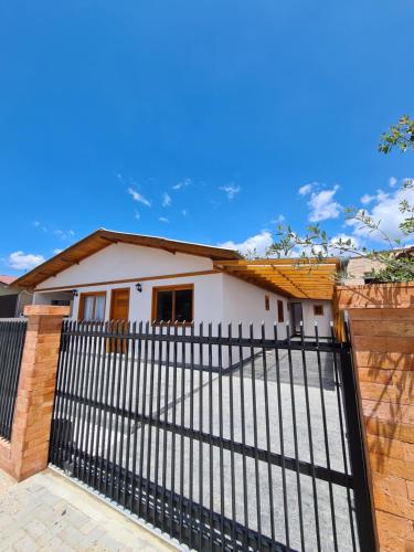 a house with a black fence in front of it at Hospedagem Casa Lorenzi 2 in Urubici
