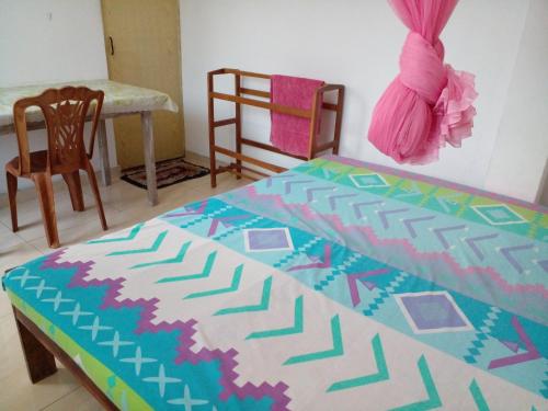 1 dormitorio con 1 cama, 1 mesa y 1 silla en Jayanthi Surf Dreams, en Midigama East