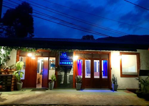 a house with colorful lights in front of it at Water Side Guest in Adams Peak