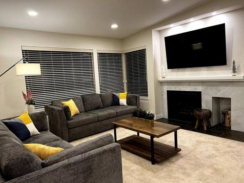 a living room with a couch and a fireplace at Luxury Condo-Downtown Bellevue in Bellevue