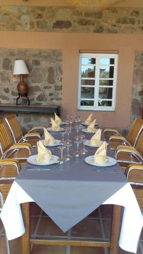 a long table with glasses and napkins on it at Le relais des sables in Tatta