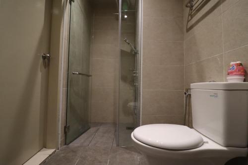 a bathroom with a toilet and a glass shower at Mykey Bali B-07-01 Melaka City in Melaka