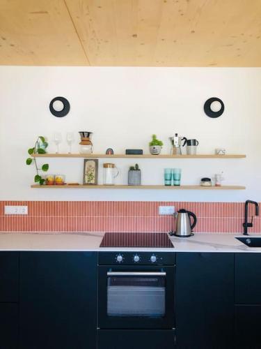 a kitchen with a stove and a counter top at New relaxing mountain getaway. in Döllach