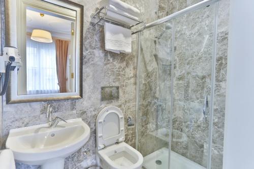 a bathroom with a sink and a toilet and a shower at HANENDE HOTEL in Istanbul