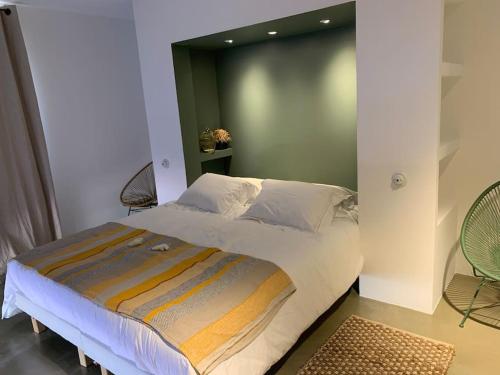 a bedroom with a large bed with a green headboard at Villa Falcone marinu ***** in Kamiesch