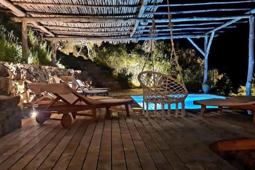 a patio with a table and chairs and a pool at Villa Falcone marinu ***** in Kamiesch