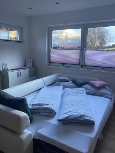 a bed in a room with two pillows on it at Leonies Appartement in Sautens