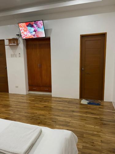 a room with a bed and a flat screen tv at Nahas Beach Resort in Abung