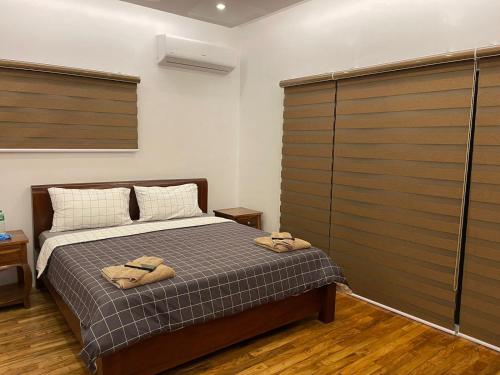 a bedroom with a bed with two towels on it at Nahas Beach Resort in Abung