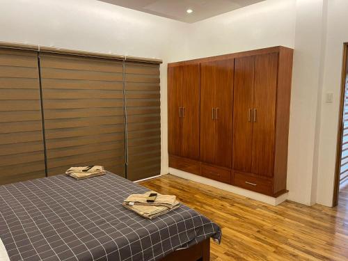 a bedroom with a bed and wooden cabinets at Nahas Beach Resort in Abung