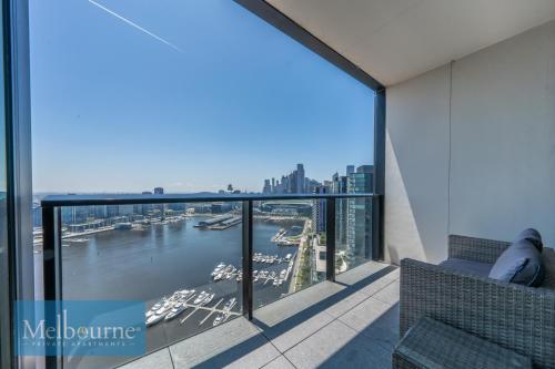 a balcony with a view of the water and boats at Melbourne Private Apartments - Collins Wharf Waterfront, Docklands in Melbourne