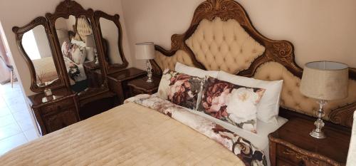 a bedroom with a large bed with pillows on it at Cozy Batchelor Labiance in Cape Town