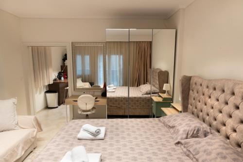 a bedroom with a bed and a living room at Ag.Sofias pedestrian area luxury ap. & big balcony in Thessaloniki