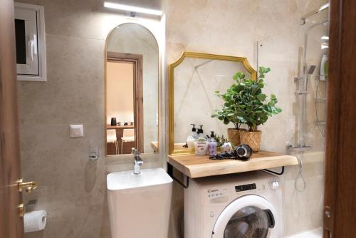 a bathroom with a washing machine and a mirror at Ag.Sofias pedestrian area luxury ap. & big balcony in Thessaloniki