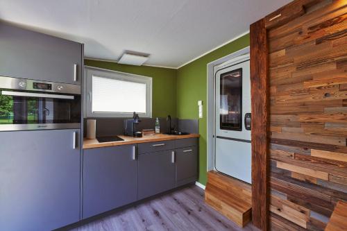 a kitchen with green walls and a counter top at Ferienanlage Kirchzarten in Kirchzarten