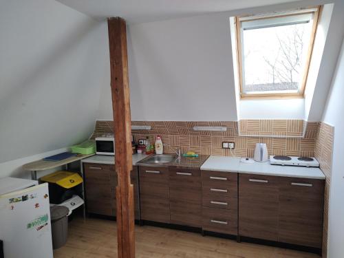 a small kitchen with a sink and a window at Apartmán v podkroví in Dobruška