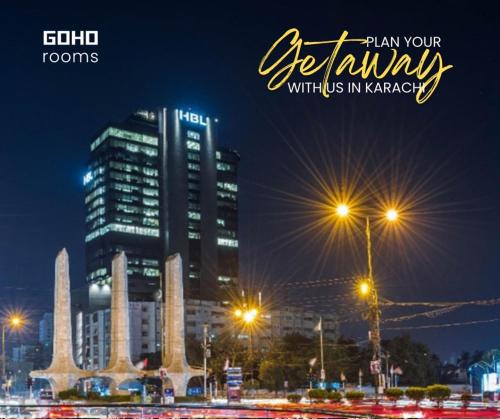 a city skyline at night with street lights and buildings at GOHO Rooms Badar in Karachi