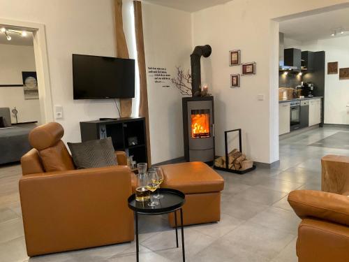 a living room with a couch and a fire place at Steigerhaus Sauerland in Bestwig