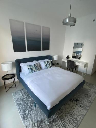 a bedroom with a large bed with a blue headboard at Stylish 2 bdr in Dubai Marina & hotels beach access available in Dubai