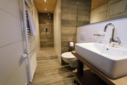 a bathroom with a sink and a toilet at Gatterhof in Riezlern