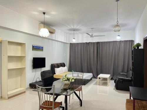 a living room with a bed and a table at Family House in Kuala Lumpur