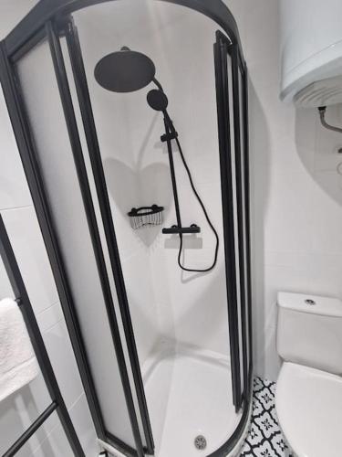 a bathroom with a shower with a lamp and a toilet at R2R - Coqueto ático - 614A in Oviedo