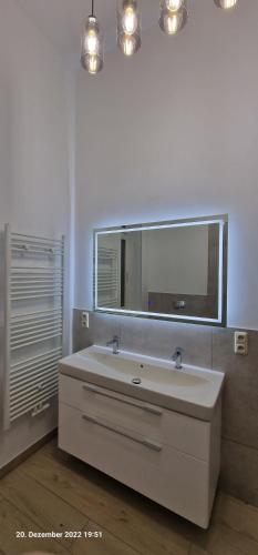 a bathroom with a white sink and a mirror at Ferienwohnung in Villa in Stralsund