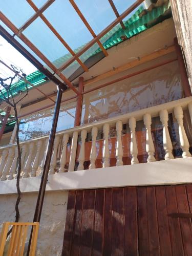 a balcony of a house with a wooden railing at Casa Titiana Suncuius in Şuncuiuş