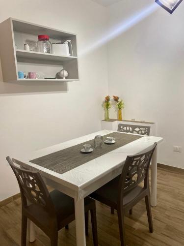 a dining room table and chairs in a room at Joya house in Taranto