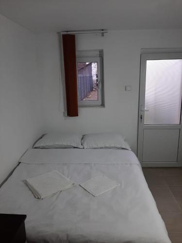 a white bed with two napkins on top of it at Vila Dionysos Brasov in Braşov