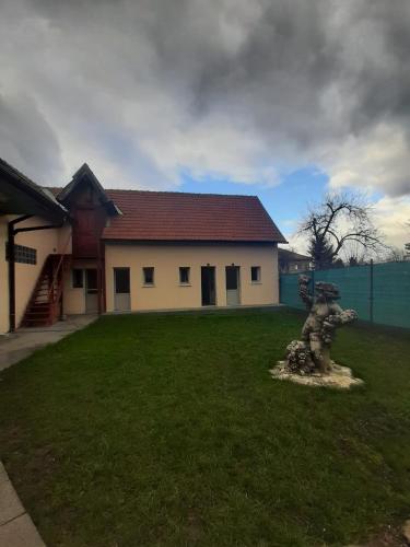 a house with a statue in front of a yard at Vila Dionysos Brasov in Braşov