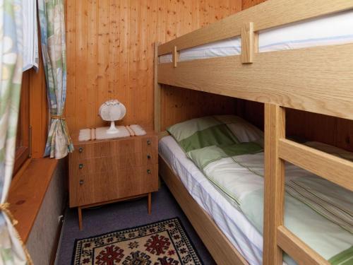 a bedroom with two bunk beds in a cabin at Serene Holiday Home in Altenfeld with Private Terrace in Altenfeld