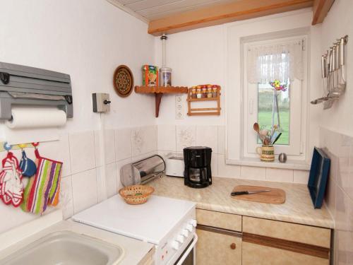 a kitchen with a sink and a counter top at Serene Holiday Home in Altenfeld with Private Terrace in Altenfeld