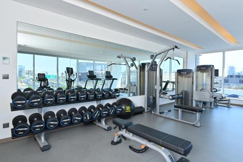 a gym with a lot of treadmills and machines at Comfort Hotel Jeddah King Road in Jeddah