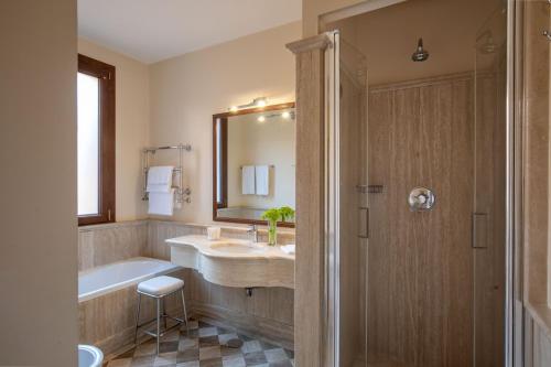 a bathroom with a sink and a tub and a mirror at Hotel Mozart in Rome